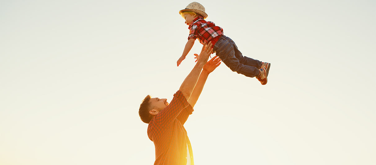 Father throws child in air and catches him